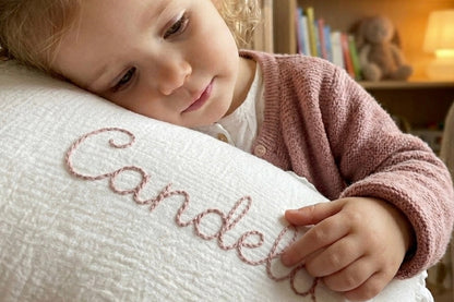 niña con cojin bordado